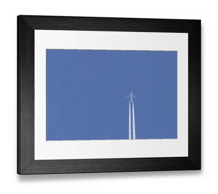 Framed Print : Boeing 737 jet passenger aircraft of Norweign Air with a vapour trial or contrail behind flying in a blue sky