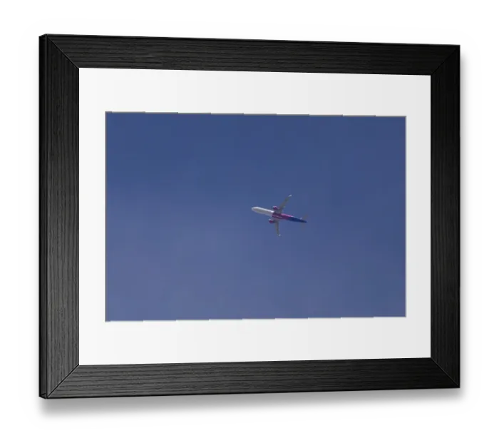 Framed Print : Airbus A321 jet aircraft of Wizz Air airlines in flight in a blue sky