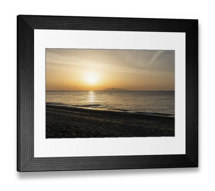 Framed Print : Dawn at sunrise, view from the lava beach Kamari to the island of Anafi