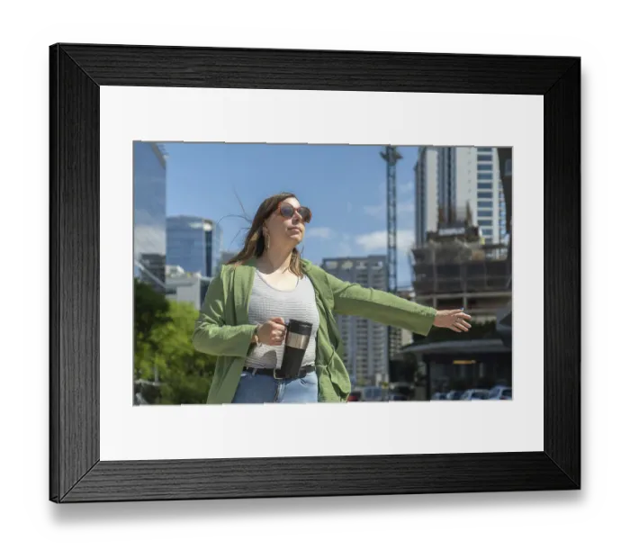 Framed Print : Businesswoman hailing a taxi in a modern city center Framed Print : Businesswoman hailing a taxi in a modern city center