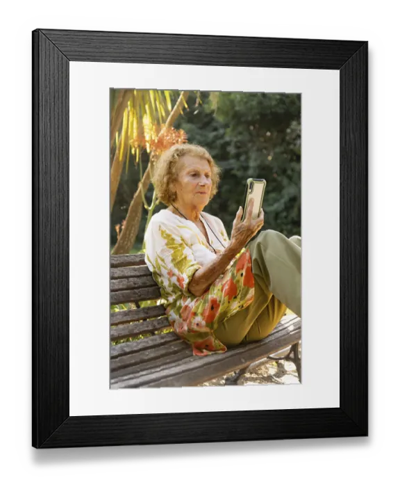 Framed Print : Elderly woman enjoying a tranquil moment in the park