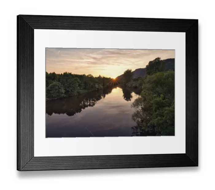 Framed Print : Rocks by the river at sunset, reflection