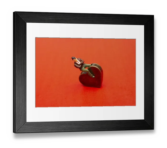 Framed Print : Man figurine on a Heart shape as love conception