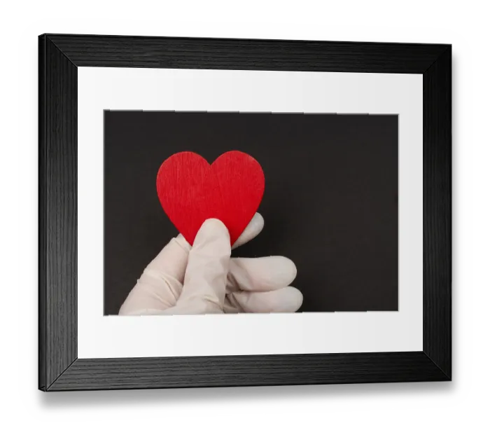 Framed Print : Hand in sterile glove hold a heart Framed Print : Hand in sterile glove hold a heart