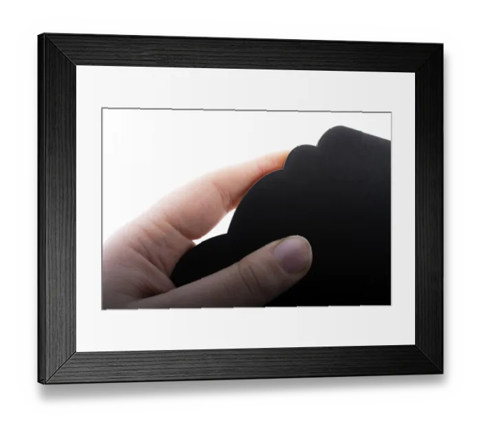 Framed Print : Black speech bubble shaped notice board in hand on white background