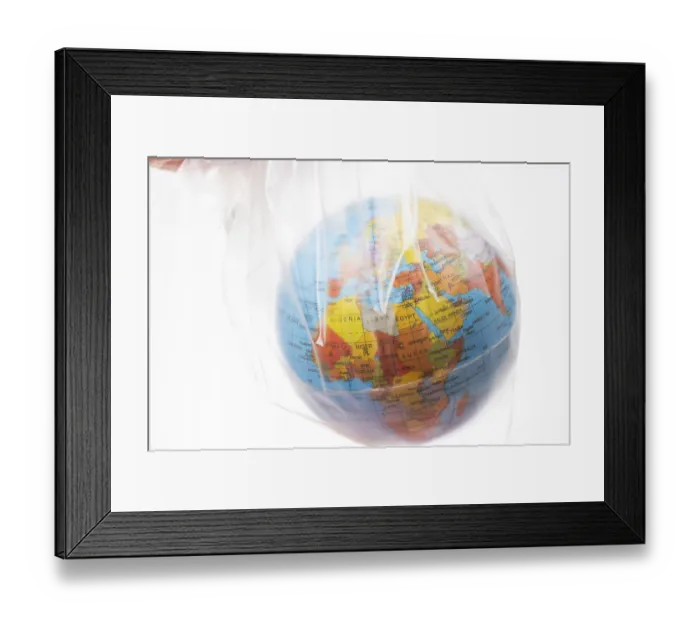 Framed Print : World globe in plastic bag isolated on white background