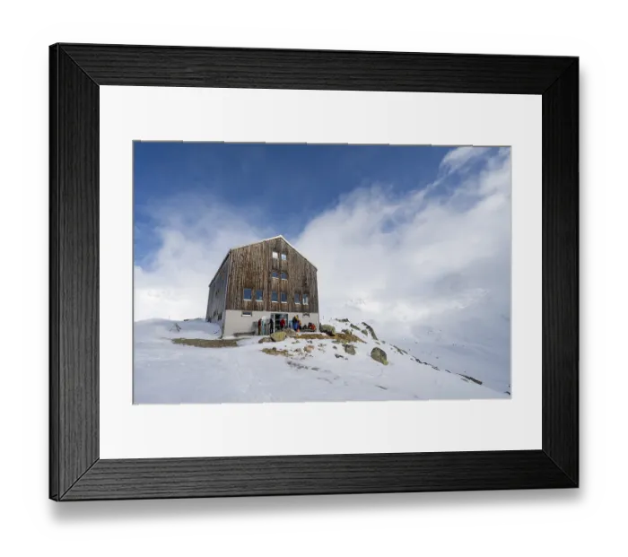 Framed Print : Chamanna Es-cha mountain hut in a cloudy winter mountain landscape