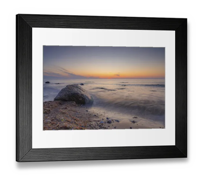 Framed Print : A peaceful sunset by the sea with a large rock in the foreground Framed Print : A peaceful sunset by the sea with a large rock in the foreground