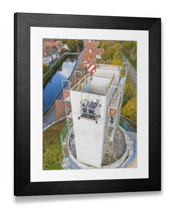 Framed Print : Workers on a high building in an urban landscape with water and surroundings