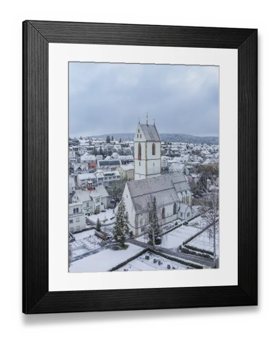 Framed Print : Snow-covered church tower and surrounding municipal buildings in a wintry landscape