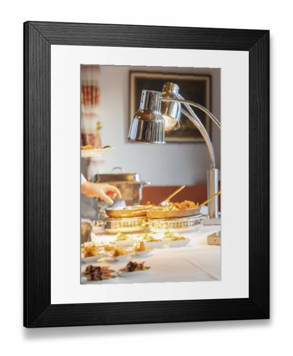 Framed Print : A fine buffet in the restaurant is lovingly presented under a lamp