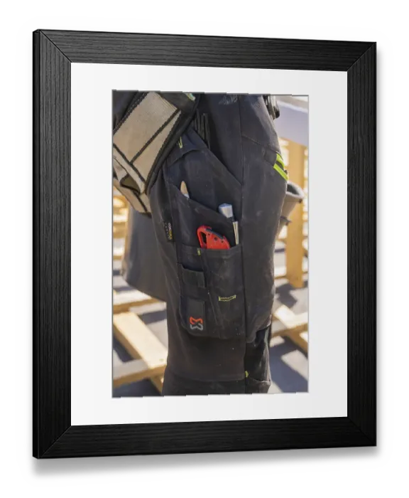 Framed Print : Tools in the pocket of a construction worker's black work trousers