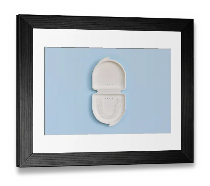 Framed Print : Customized transparent dental teeth bite guard clear aligners for lower jaw in white case on blue background