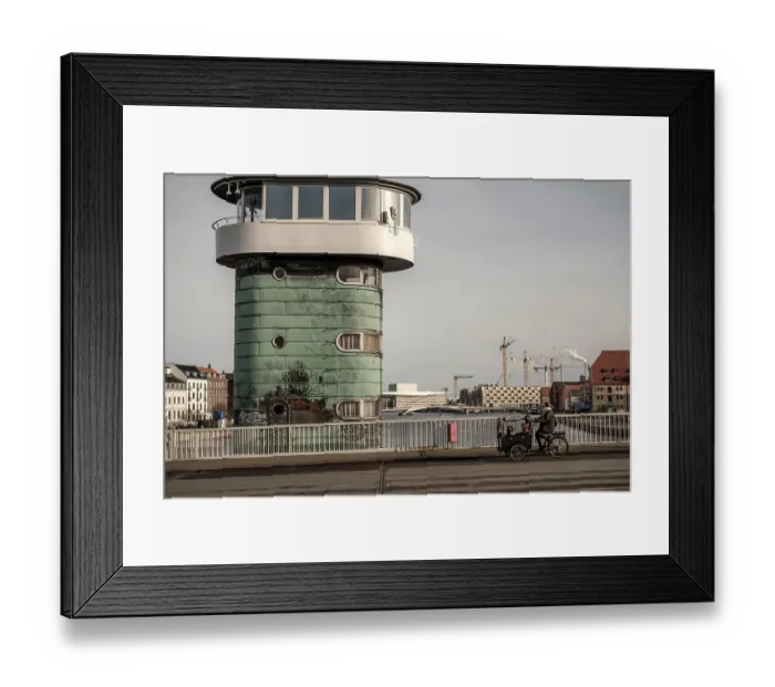 Framed Print : A green architectural tower by a bridge with a cyclist and cranes in the urban scene in Copenhagen Framed Print : A green architectural tower by a bridge with a cyclist and cranes in the urban scene in Copenhagen