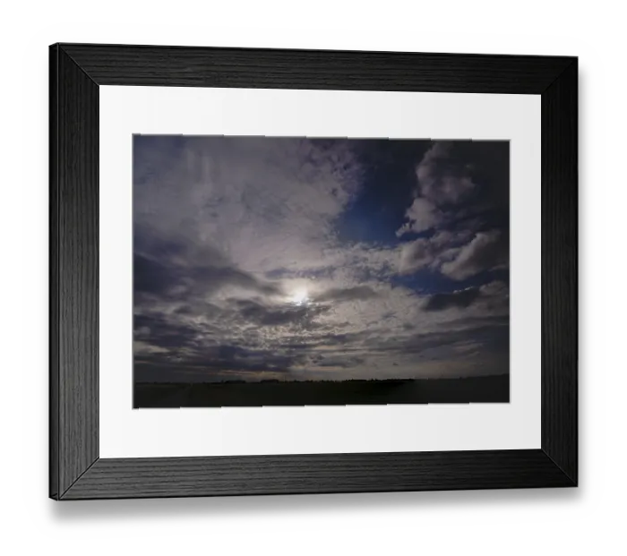 Framed Print : Dark clouds in the sky with sun in the backlight