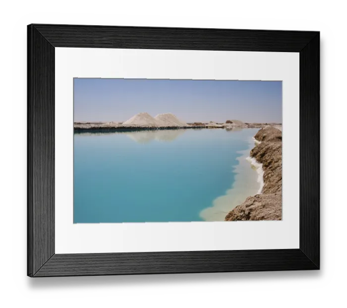 Framed Print : Salt lake with turquoise water and white salt hills on the shore