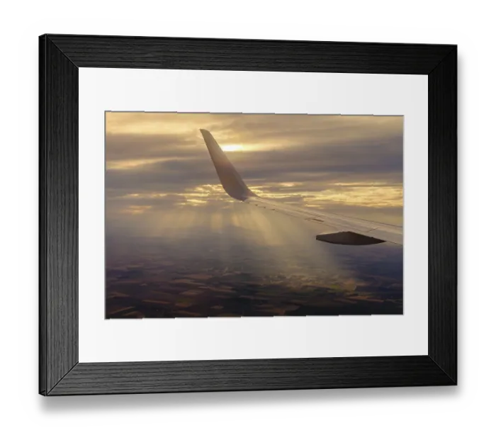 Framed Print : Wing of the plane during the flight with sun rays in the background Framed Print : Wing of the plane during the flight with sun rays in the background