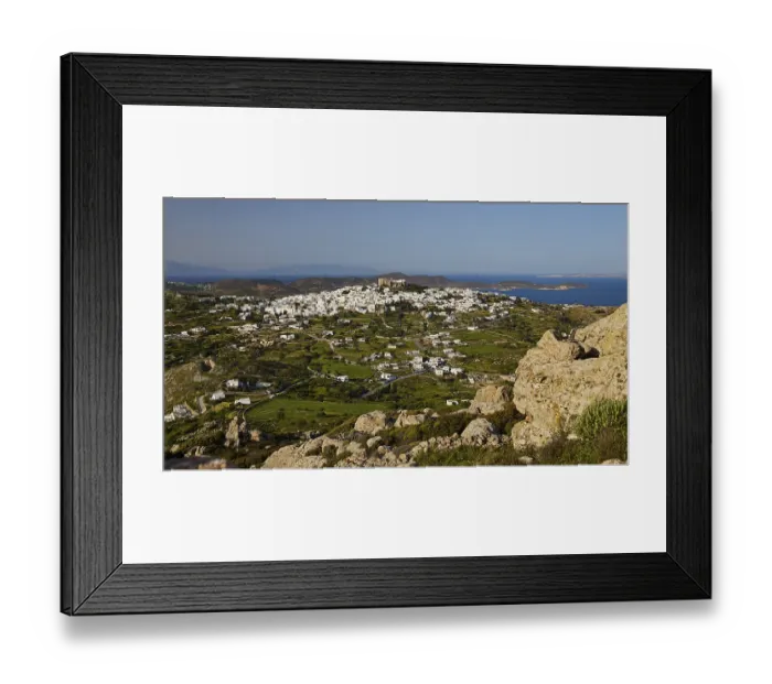 Framed Print : View of a village and green pastures with a distant coastline Framed Print : View of a village and green pastures with a distant coastline