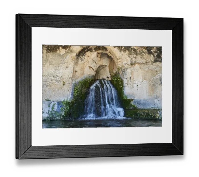Framed Print : Nymph grotto, Small waterfall flowing from a rocky cave with moss growth
