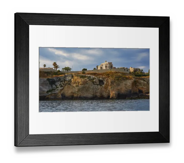 Framed Print : Building on a cliff under a cloudy sky next to the sea Framed Print : Building on a cliff under a cloudy sky next to the sea