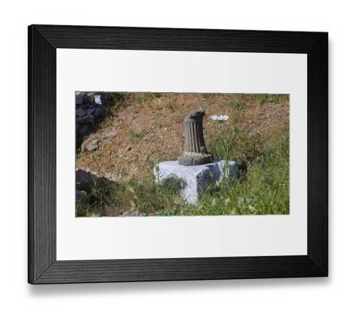 Framed Print : An old column on a pedestal surrounded by grass at a historical site