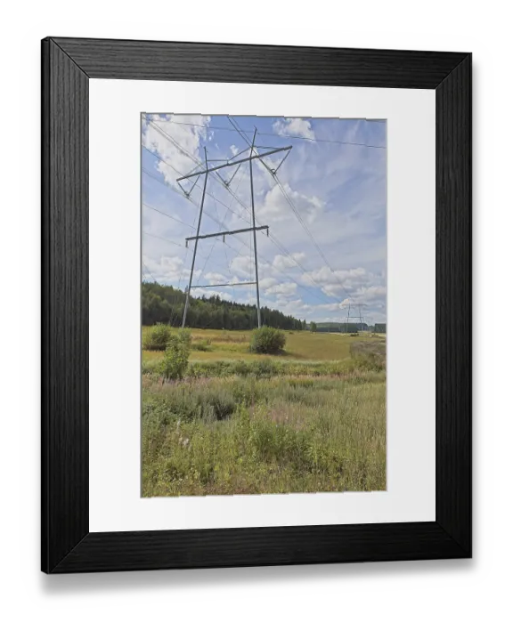 Framed Print : Pylon and power lines on a cloudy summer day