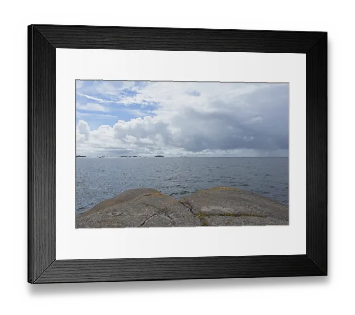 Framed Print : Rocky seashore on the island of Jussaro in cloudy summer weather