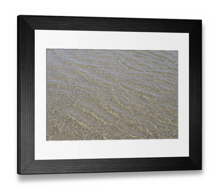 Framed Print : Evenly flowing waves on a sandy beach