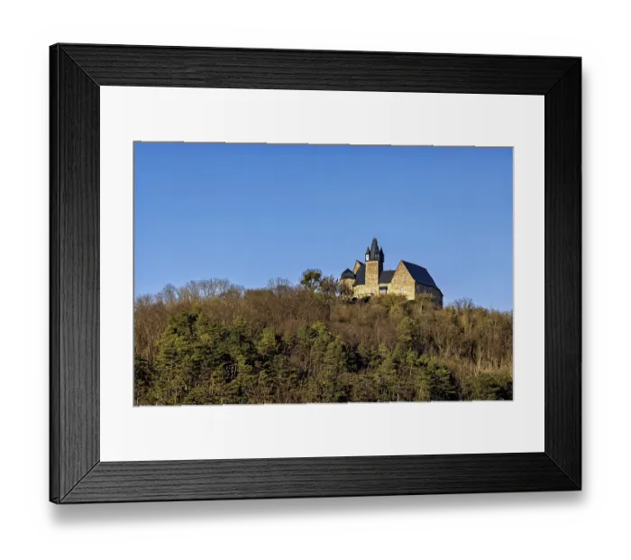 Framed Print : Castle in the distance on a wooded hill