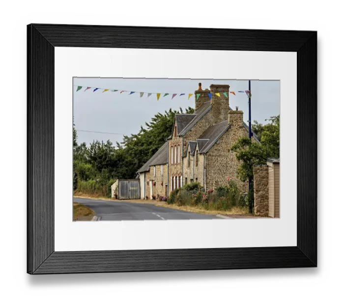 Framed Print : A traditional stone house on a rural road with festive garlands