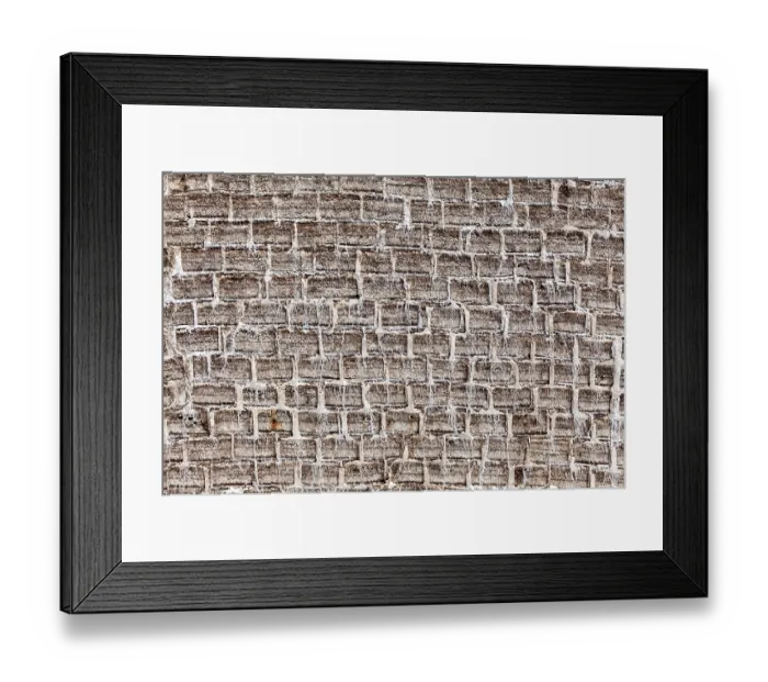 Framed Print : General view of a textured brick wall in earthy tones with an antique look