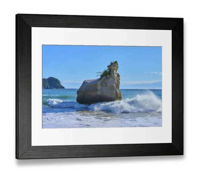Framed Print : Energetic waves crash against a huge rock in the sea