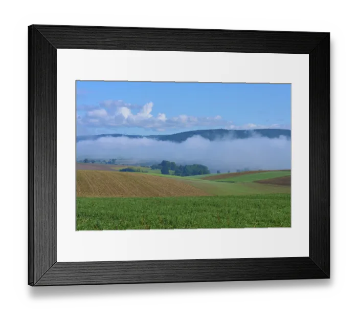 Framed Print : Hilly fields with fog and clear blue sky