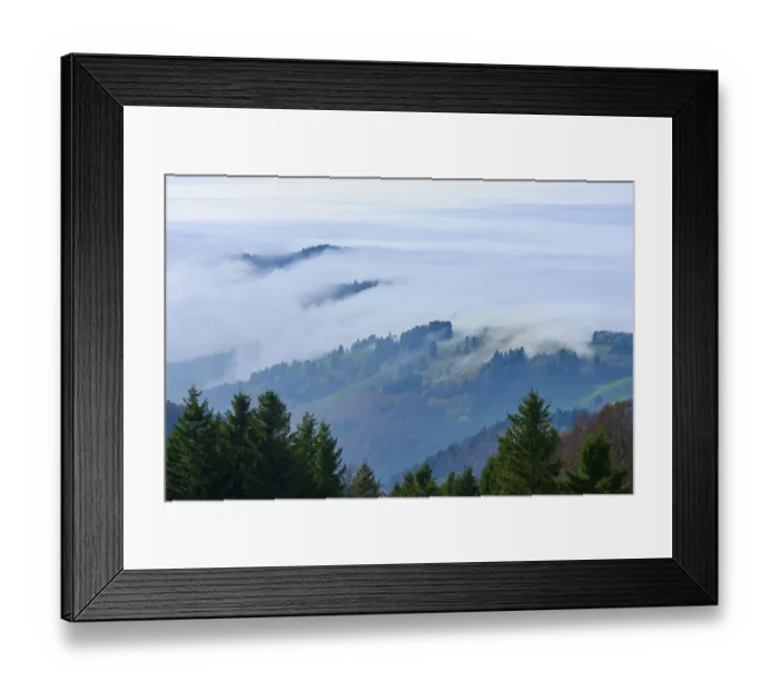 Framed Print : Hills and forests rise out of dense