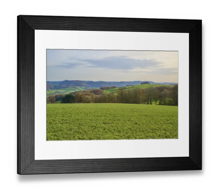 Framed Print : Hilly green landscape with trees and wind turbines on the horizon Framed Print : Hilly green landscape with trees and wind turbines on the horizon