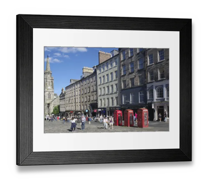Framed Print : Lively street view with historic buildings and striking red telephone boxes in daylight