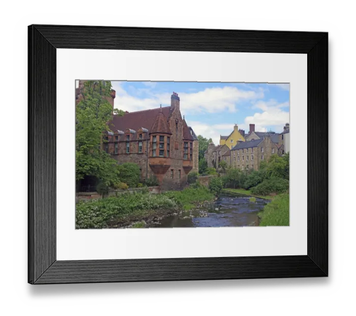 Framed Print : Historic waterfront buildings with green trees and clear skies