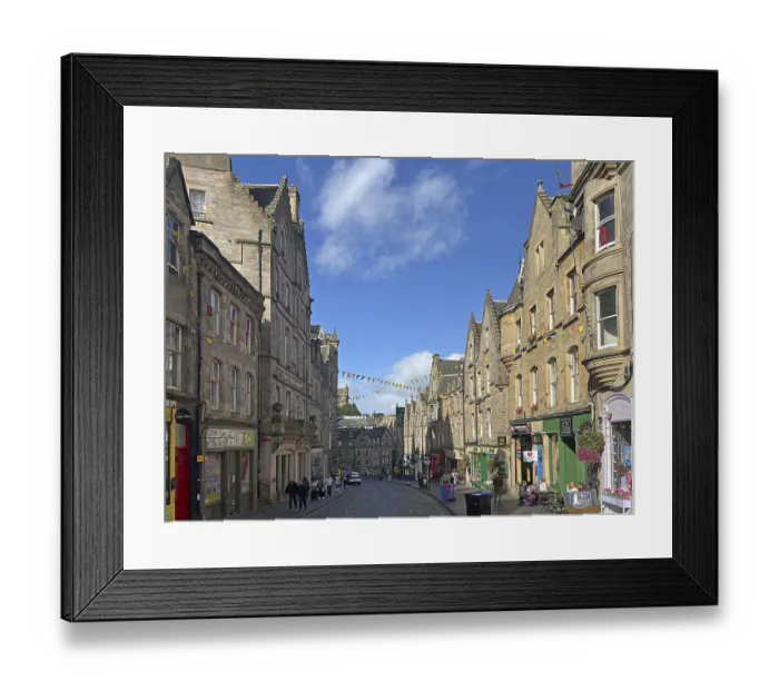 Framed Print : Historic street lined with old buildings under a clear sky Framed Print : Historic street lined with old buildings under a clear sky