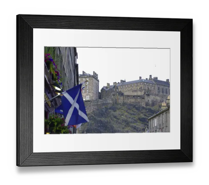 Framed Print : Scottish castle on a hill surrounded by buildings and a Scottish flag