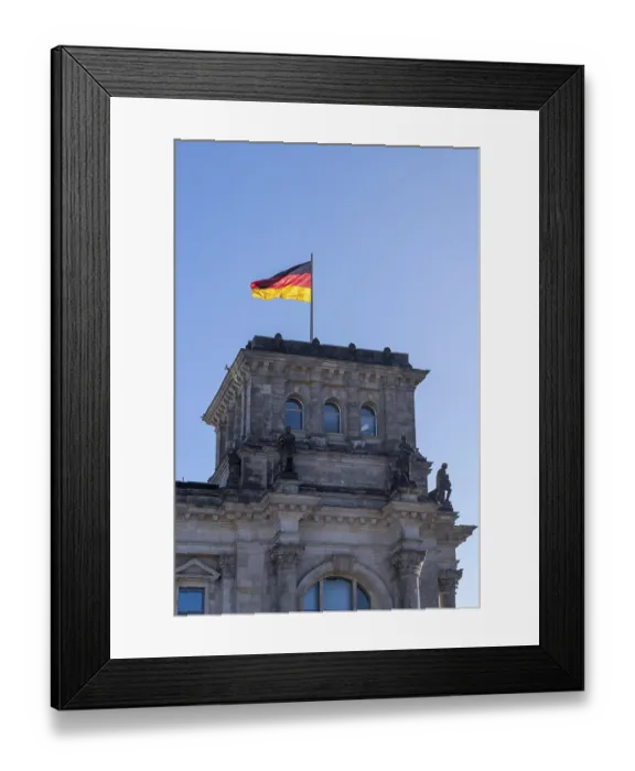 Framed Print : The Reichstag building with the German flag in front of a clear blue sky