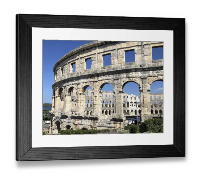 Framed Print : View of an ancient amphitheatre with stone arches under a blue sky