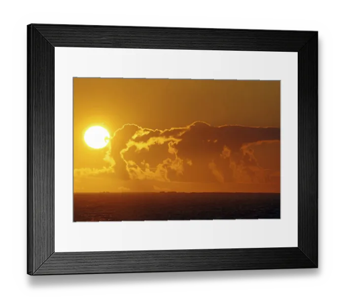 Framed Print : Dramatic sunset over the sea with glowing cloud formations Framed Print : Dramatic sunset over the sea with glowing cloud formations