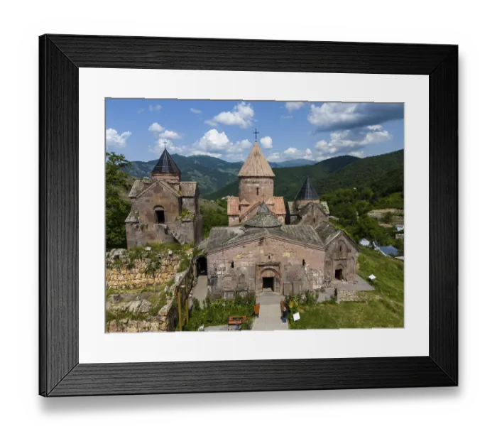 Framed Print : Historic Armenian monastery against a mountain backdrop and blue sky