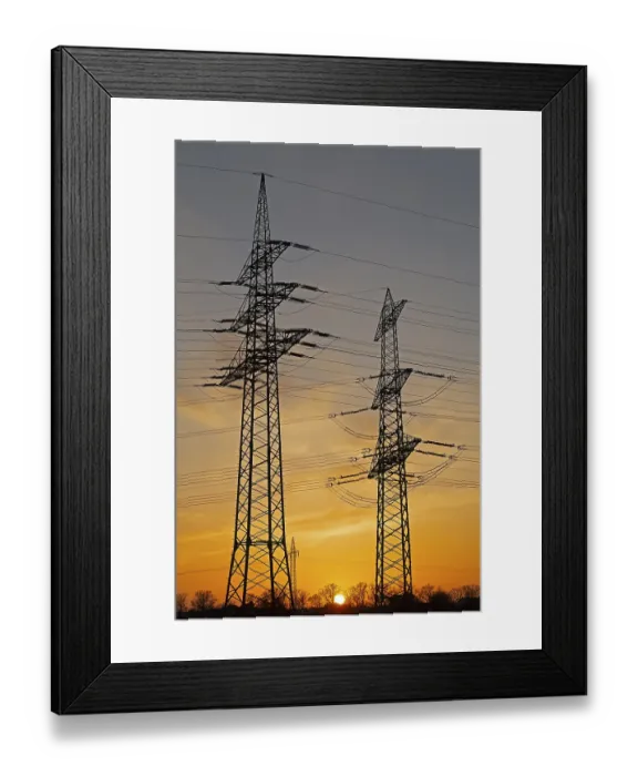 Framed Print : Sunset behind high-voltage pylons