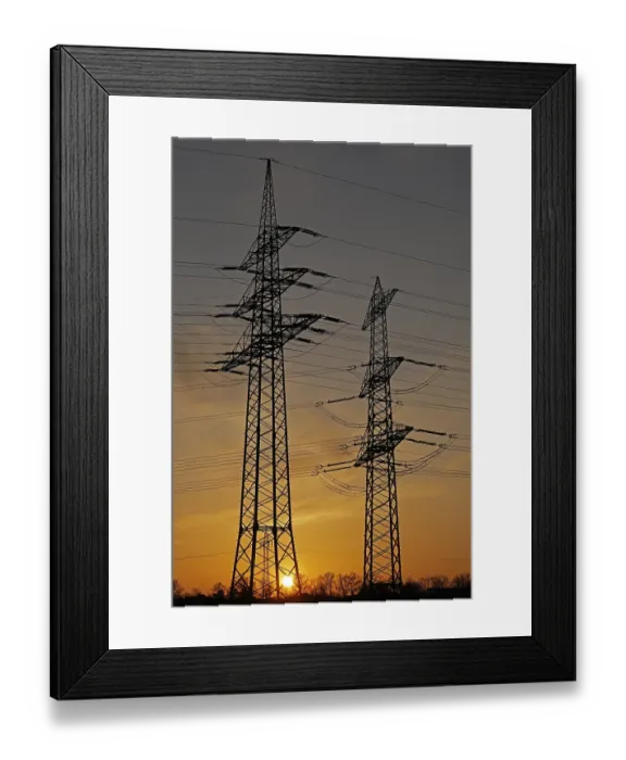 Framed Print : Sunset behind high-voltage pylons