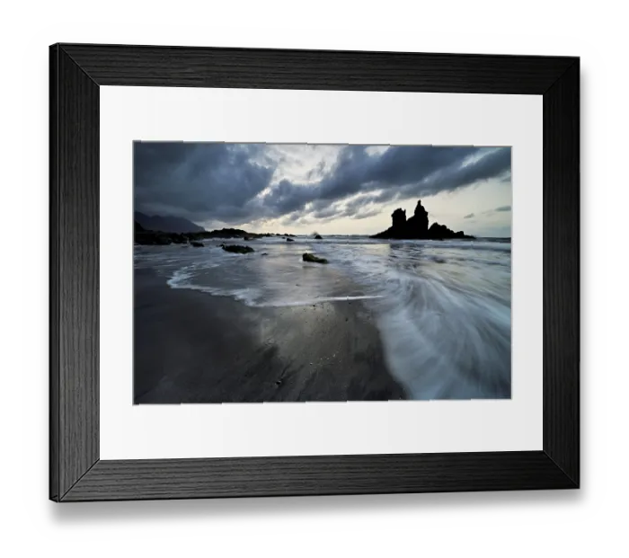 Framed Print : Dramatic clouds with rock formation at rising tide at the beach of Playa de Benijo