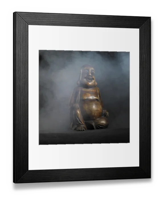 Framed Print : Brown Buddha sculpture in dark smoky back Framed Print : Brown Buddha sculpture in dark smoky back