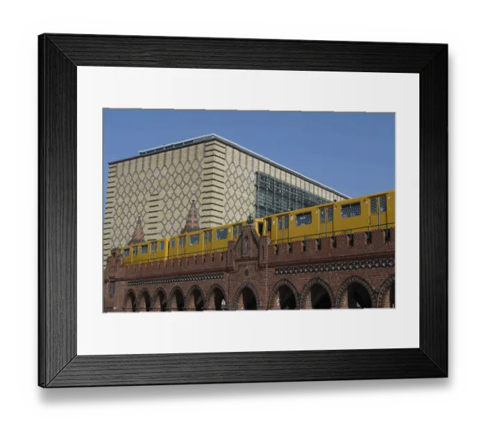 Framed Print : A yellow underground train crosses a brick bridge in Berlin with modern architecture behind it Framed Print : A yellow underground train crosses a brick bridge in Berlin with modern architecture behind it