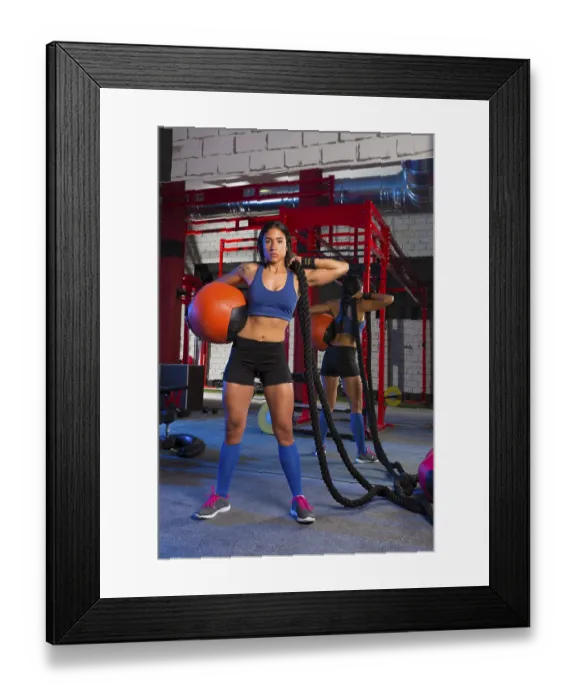 Framed Print : Brunette gym woman with weighted ball and rope posing