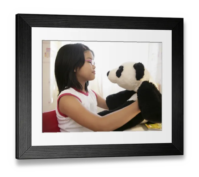 Framed Print : Asian girl looking at her panda teddy bear Framed Print : Asian girl looking at her panda teddy bear